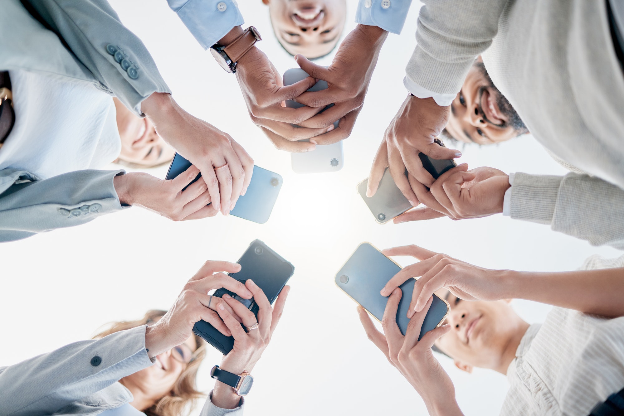 Phone in hands, technology and business people with collaboration and communication in team for com